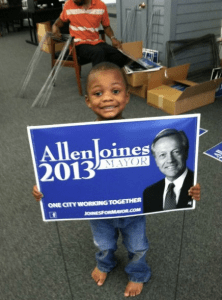 Child with yard sign